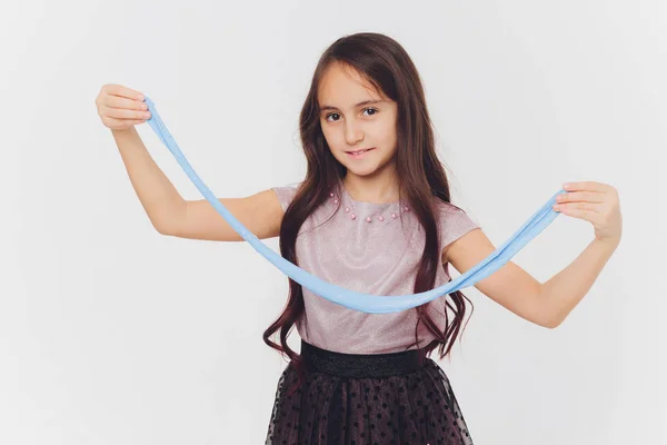 Young girl playing with slime. Isolated on white background. — Stock Photo, Image