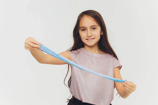 Young girl playing with slime. Isolated on white background. — Stock Photo, Image