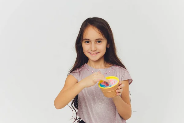 Young girl playing with slime. Isolated on white background. — Stock Photo, Image