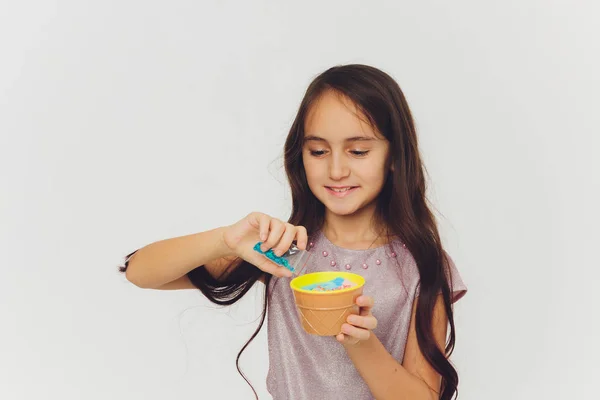 Young girl playing with slime. Isolated on white background. — Stock Photo, Image