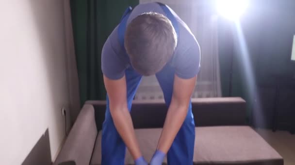 Čistírna oděvů zaměstnanec odstraňování nečistot z nábytku v bytě, detailní záběr. — Stock video