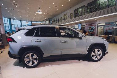 Ufa, Russia, 15 January, 2020: All-new compact crossovers Toyota RAV4 premier at Toyota car standing next to showroom entrance.