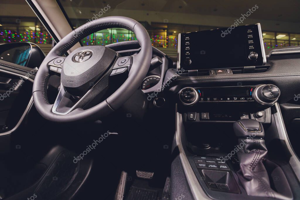 Ufa, Russia, 15 January, 2020: All-new compact crossovers Toyota RAV4 premier at Toyota car standing next to showroom entrance