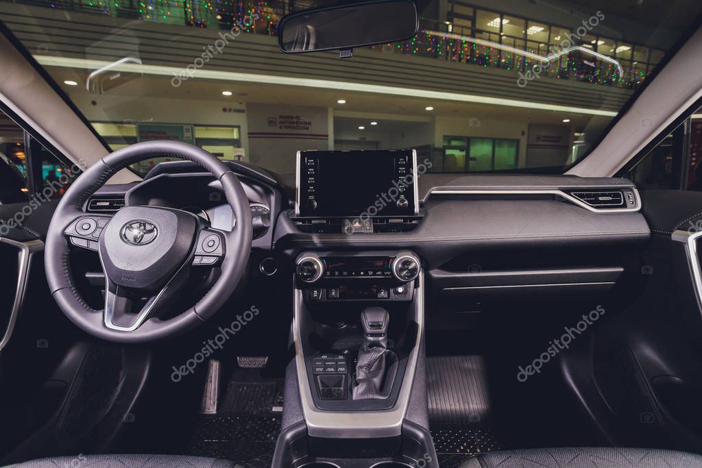 Ufa, Russia, 15 January, 2020: All-new compact crossovers Toyota RAV4 premier at Toyota car standing next to showroom entrance