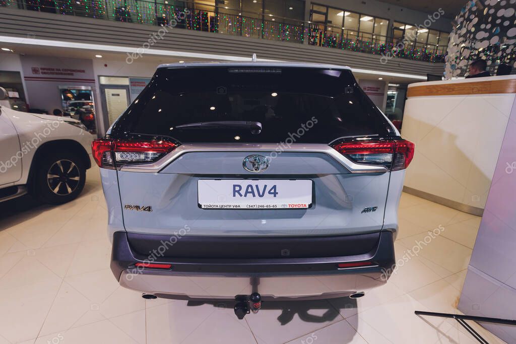 Ufa, Russia, 15 January, 2020: All-new compact crossovers Toyota RAV4 premier at Toyota car standing next to showroom entrance