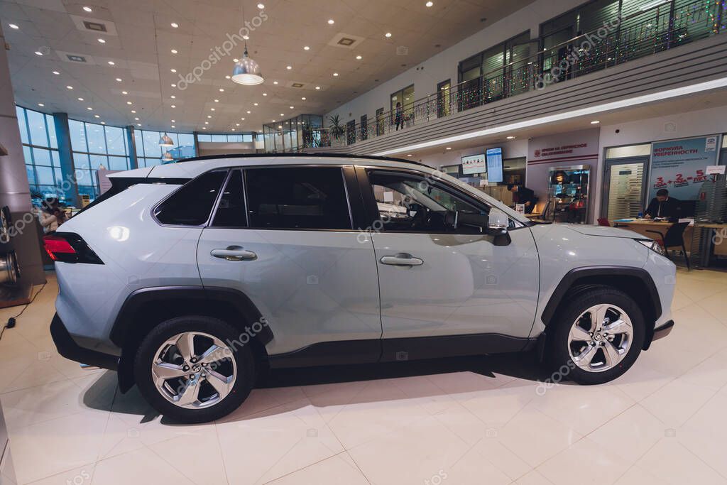 Ufa, Russia, 15 January, 2020: All-new compact crossovers Toyota RAV4 premier at Toyota car standing next to showroom entrance