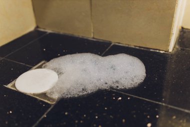 Abstract bubbles white foam of washing powder on grey floor.bubbles soap cleaning floor.