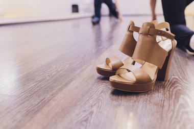 black and pink strip dance shoes on yellow background. studio fashion.