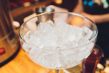 bartender prepares a great cocktail close-up on the background of the bar.