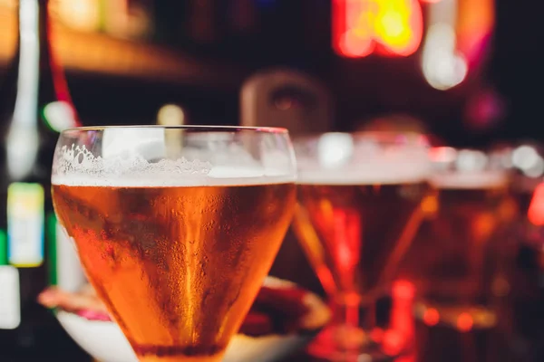 Cold beer glass on bar or pub desk.