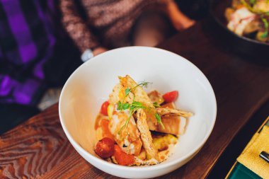 Grilled salmon fish with fresh vegetables on plate.