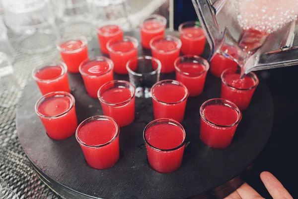 Several red alcohol shots on a bar. — Stock Photo, Image