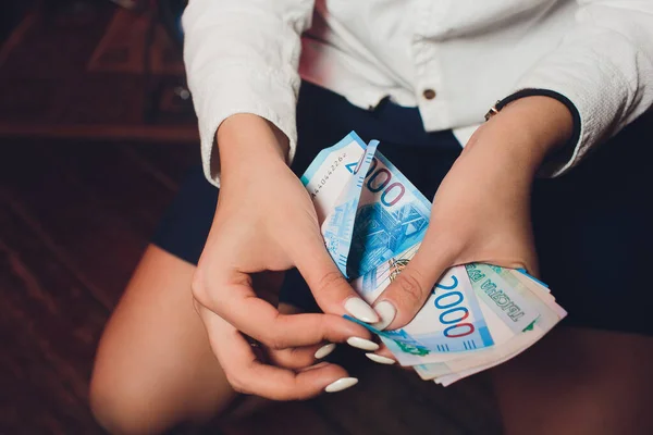 Russian rubles in the hand of a fan.male hand holding many of the Russian banknotes.The transfer of money.The isolated five-thousandth of Russian rubles denominations in a hand.