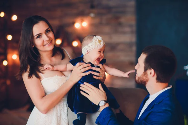 Young beautiful happy family in elegant clothes with little smiling child. — Stock Photo, Image