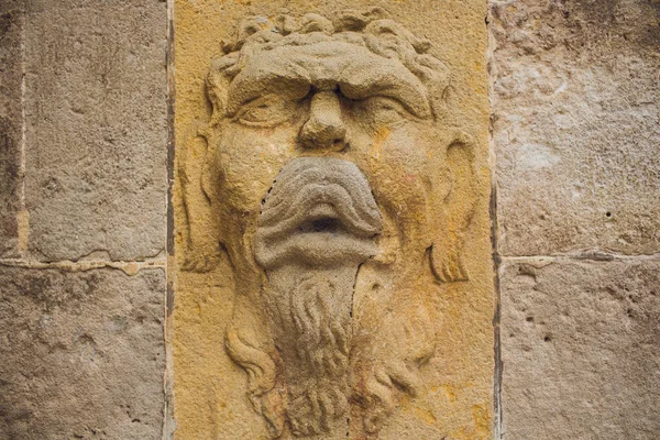 BARCELONA, SPAIN, August 11 2018: Bas relief decorative mask sculpture on the walls of famous Comedia movie theatre in Barcelona, Spain.