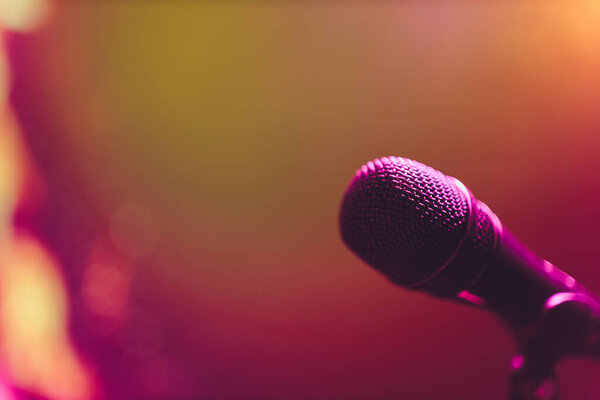 Close up of microphone on stage in audience room blur background.