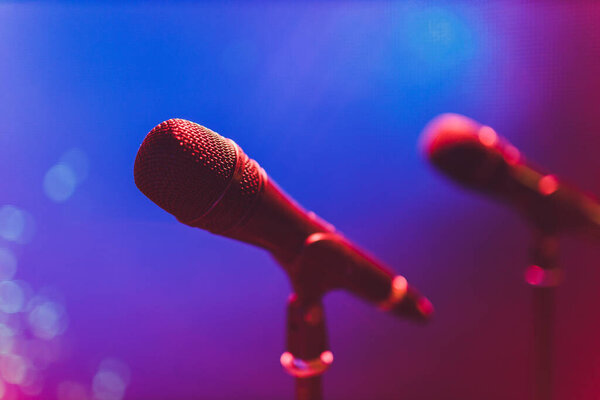 Close up of microphone on stage in audience room blur background.