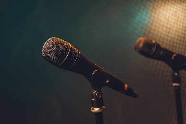 Close up of microphone on stage in audience room blur background.