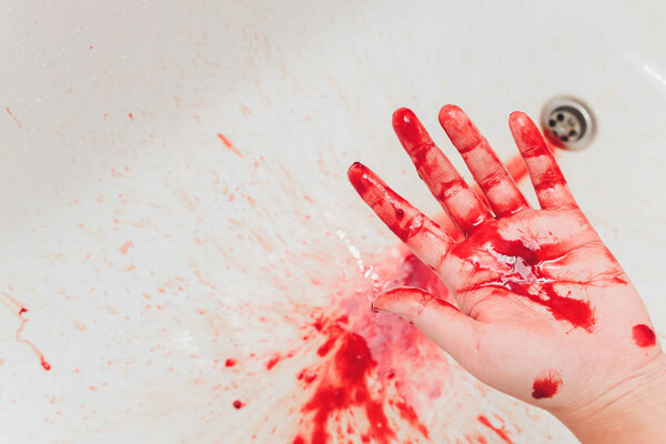 Bloody in sink with flowing red blood. Murder concept background. hand