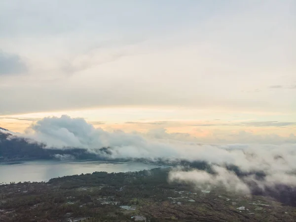 Scenic view of clouds and mist at sunrise from the top of mount Batur Kintamani volcano , Bali, Indonesia.