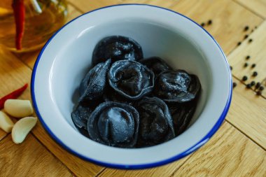 Masadaki beyaz tabakta siyah hamur köfteleri..