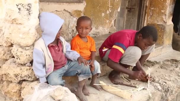 Zanzibar, Tanzanie - 15. července 2019: Africké dítě s vyholenou hlavou hledí vzhůru, velké vážné oči. — Stock video