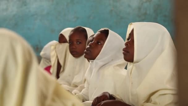 Zanzibar, Tanzania - 15 lipca 2019: Afrykańskie dziecko z ogoloną głową patrzące w górę, duże poważne oczy. w szkole dla dzieci — Wideo stockowe