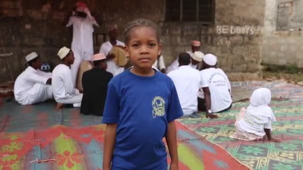 Zanzíbar, Tanzania - 15 de julio de 2019: Niño africano con la cabeza afeitada mirando hacia arriba, grandes ojos serios . — Vídeos de Stock