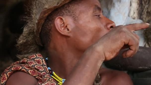 Zanzibar, Tanzania - 12 december 2019: Afrikaanse man masai gekleed in traditionele kleding bij de oceaan op het zandstrand van Zanzibar eiland, Tanzania, Oost-Afrika, close-up — Stockvideo