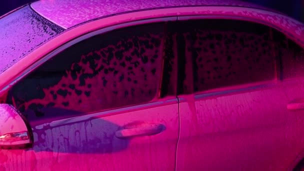 Close up cleaning car using high pressure water,High pressure jet washer in process of car washing. pink color foam — Stock Video