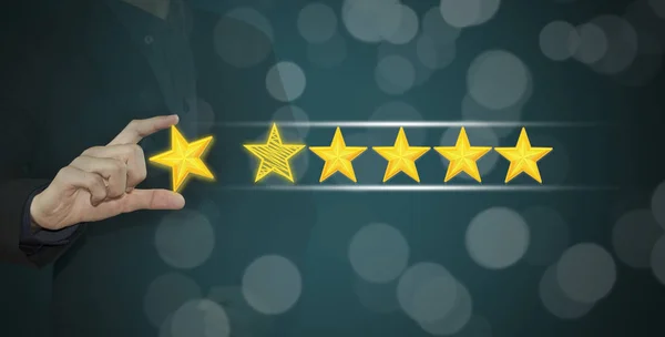 Business hand select yellow marker on five star rating.