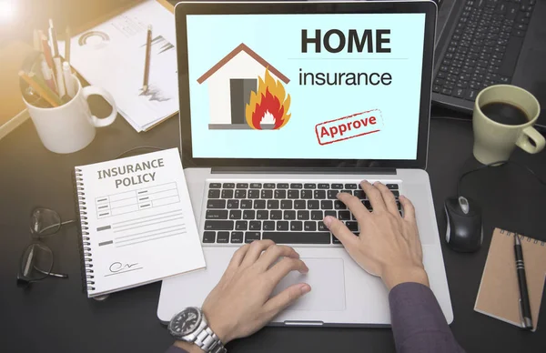 Business hand using computer with protection house insurance Royalty Free Stock Images