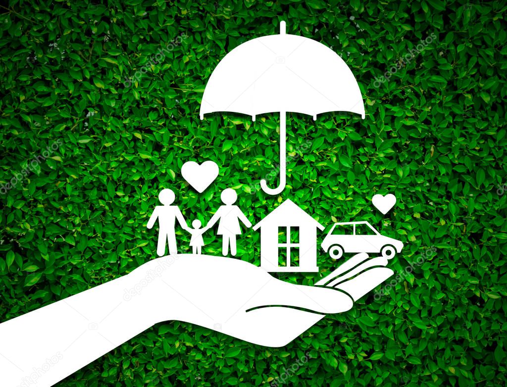 paper salesman agent hand holding family protection on green