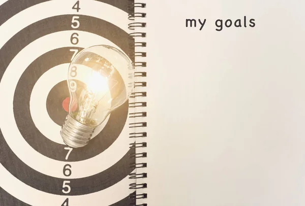 Lightbulb on dartboard. concept my goal for new ideas — Stock Photo, Image