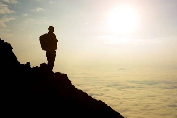 silhouette adventurer team on the mountain and sunrise.