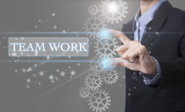 Businessman hand select wording Teamwork. sign on virtual screen