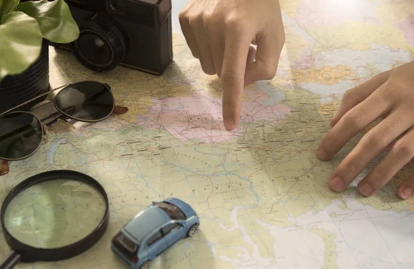 tourist pointing on the world map for planning vacation