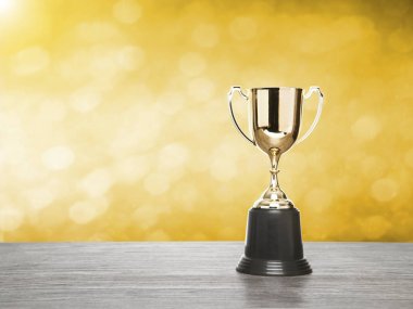 winner cup with gold bokeh background. copy space ready  clipart