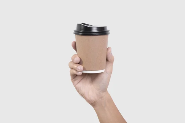 Mão segurando copo de papel de café isolado no fundo cinza . — Fotografia de Stock