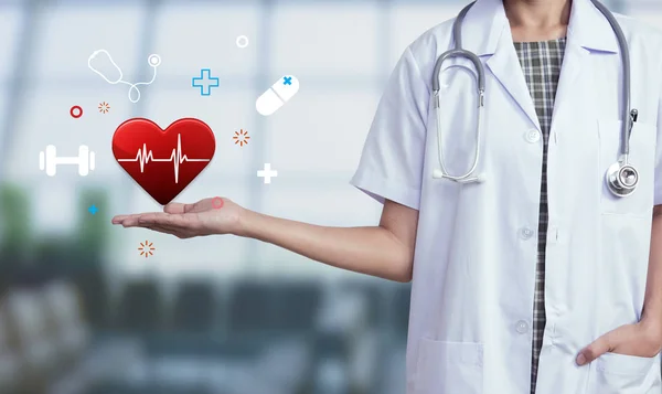 Женщина-врач со стетоскопом держит икону сердца. концепция здоровье — стоковое фото