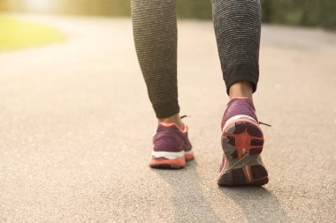 Genç atlet kadınlar Road günbatımı arka plan ile koşu. Sağlıklı yaşam konsepti.