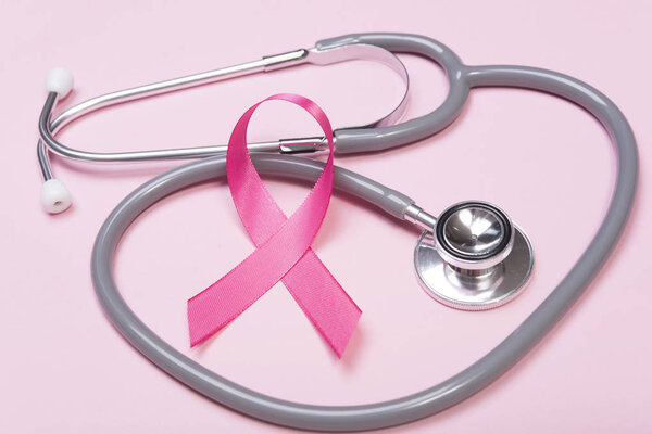pink ribbon breast cancer and stethoscope on pink background. 