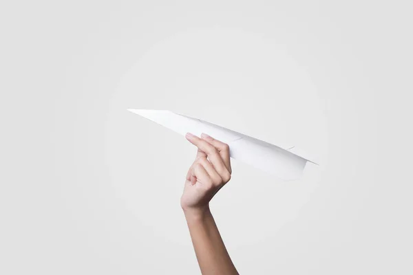 Main tenant avion en papier isolé sur fond gris . — Photo