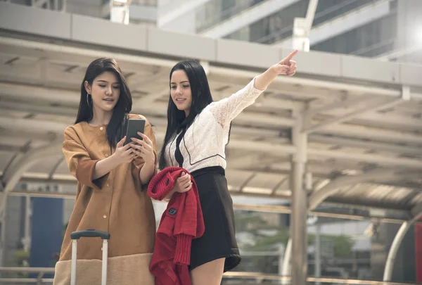 young woman tourist using gps map in a smart phone in the city