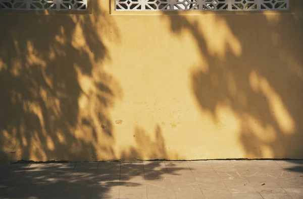 yellow wall and shadow abstract for background.
