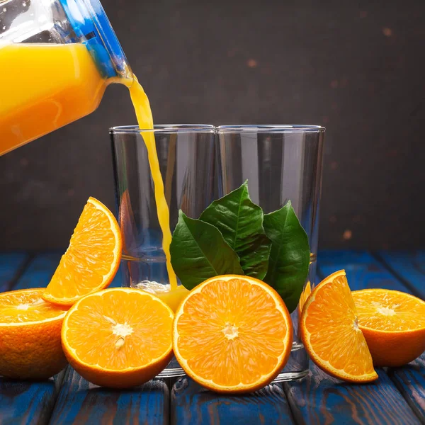 Pouring orange juice. Freshly squeezed orange juice. Healthy eating