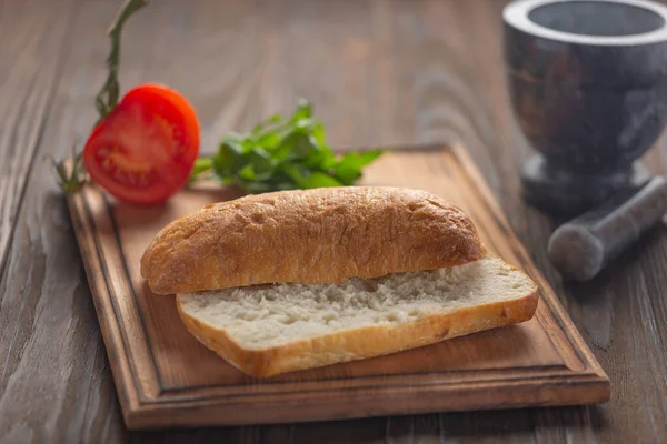 Bread, submarine sandwich, panini, arugula salad bacon, fresh ciabatta, yellow cheese, sun dried — Stock Photo, Image