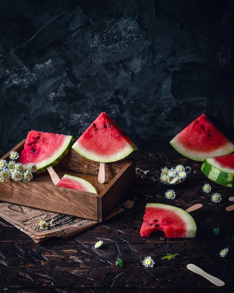 Watermelon slices on wooden sticks