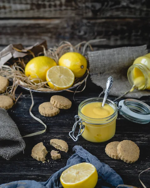 Lemon curd in glass jar with spoon — Stock Photo, Image