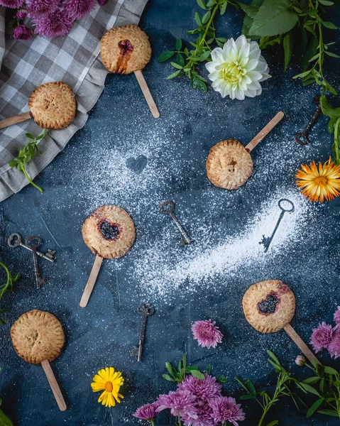 Fruit pies served on wooden sticks — Stock Photo, Image